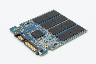 Close-up view of the interior components of a SATA SSD, showing the memory chips and controller board.