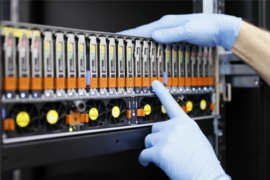 Technicians in a cleanroom performing server RAID data recovery, using advanced methods and equipment to restore lost data.