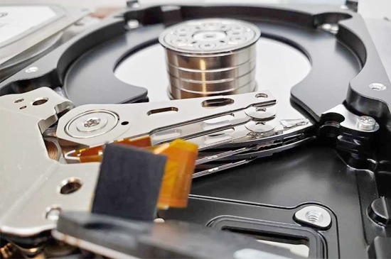 Technician performing Seagate data recovery, working with Seagate hard drives and specialized recovery equipment in a lab.